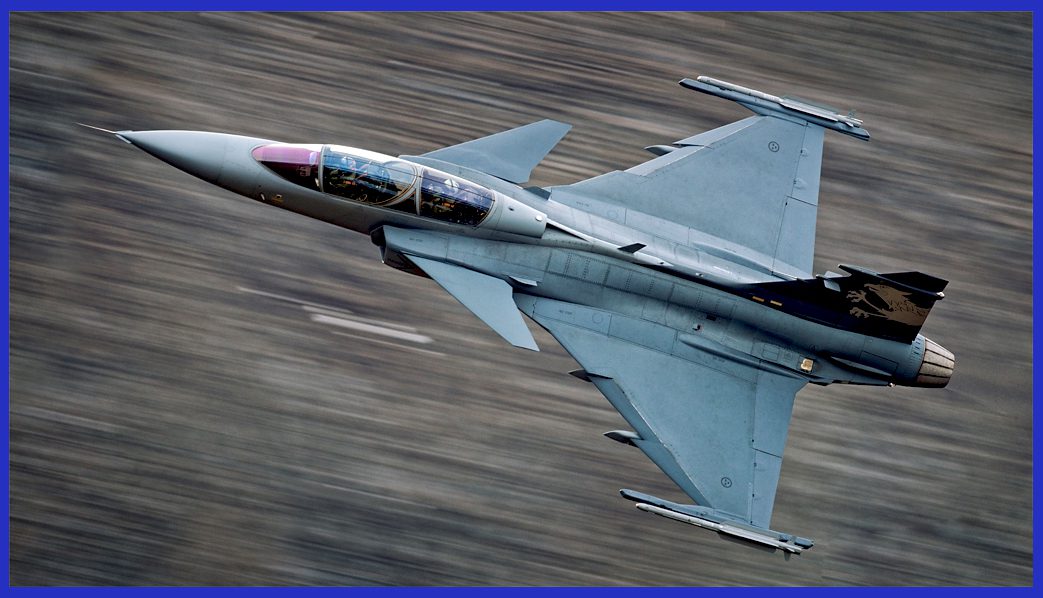 A low-altitude Gripen, armed with two IRIS-T AAMs on its wingtips, skillfully maneuvers near the terrain, effectively evading radar detection