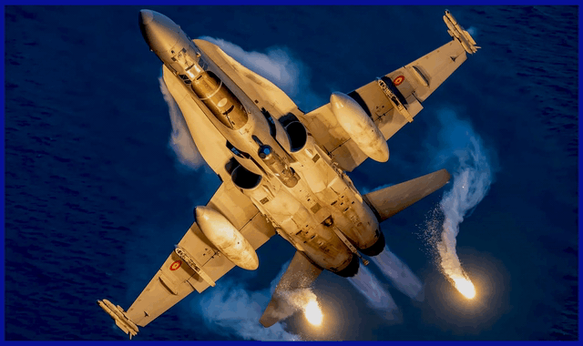 Photo Credit: Hesja Air-Art Photography / The F-18 Hornet is powered by the GE F404 engine, utilizing full afterburner and ejecting chaff dispensers in an aggressive maneuver