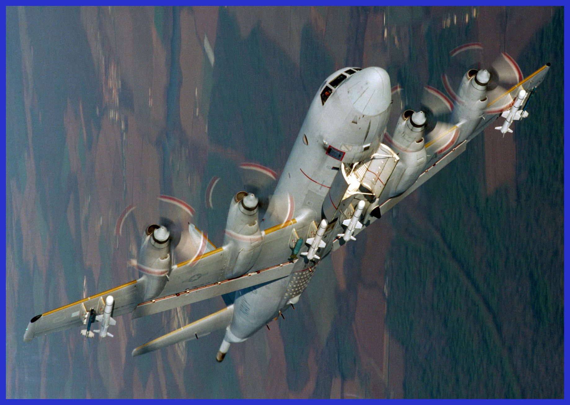 Photo Credit: USN / A very rare image showing a P-3C Orion being equipped with four AGM-84 Harpoon missiles and two Sidewinder air-to-air missiles